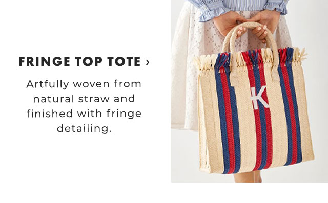 FRINGE TOP TOTE › Artfully woven from natural straw and finished with fringe detailing.