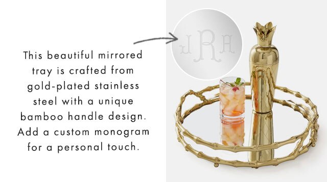 This beautiful mirrored tray is crafted from gold-plated stainless steel with a unique bamboo handle design. Add a custom monogram for a personal touch. 