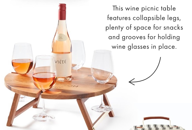 This wine picnic table features collapsible legs, plenty of space for snacks and grooves for holding wine glasses in place.